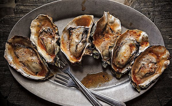 Plate of BBQ chipotle grilled oysters.